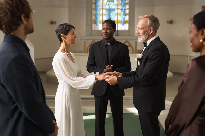 Senior Bride and Groom Holding Hands at Church Altar on Wedding Day