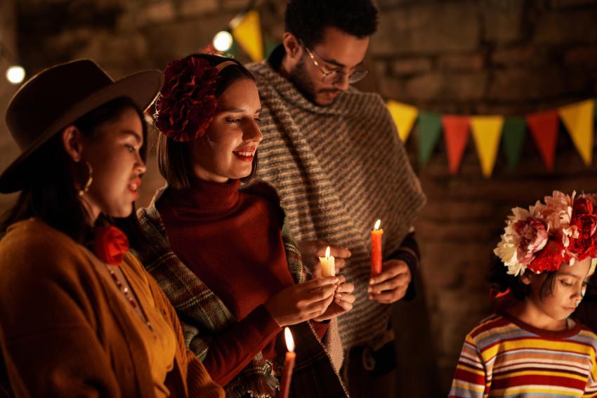 People lighting candles in honour of dead